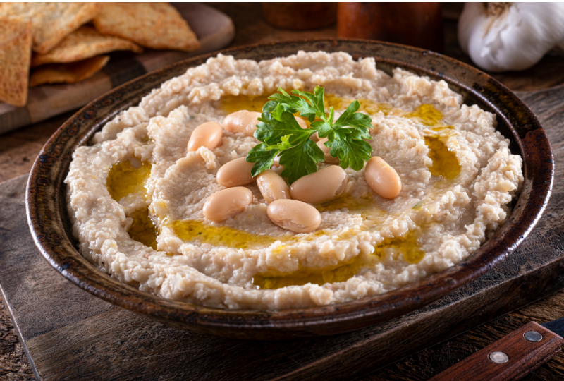 A bowl of haricot bean mash with olive oil drizzle